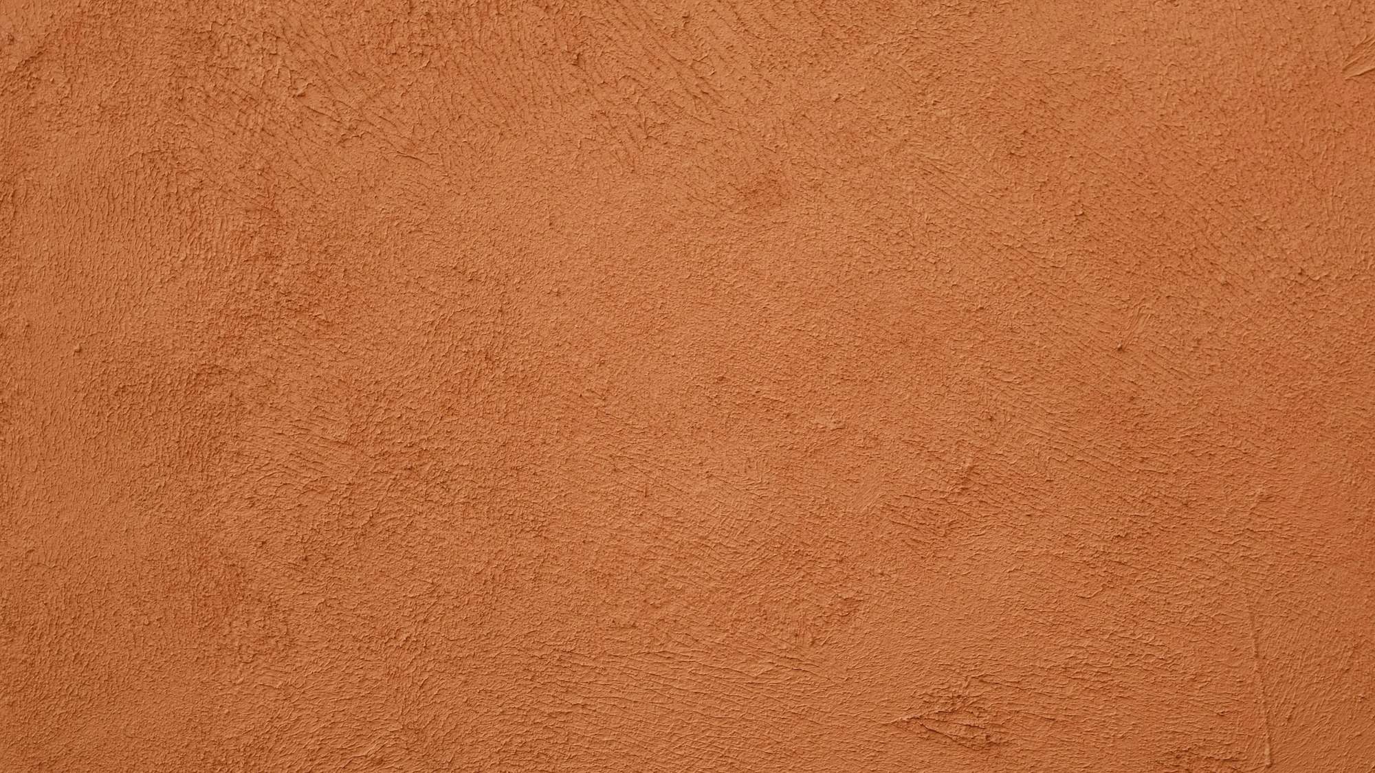 Un muro de yeso color ocre con una sombra suave