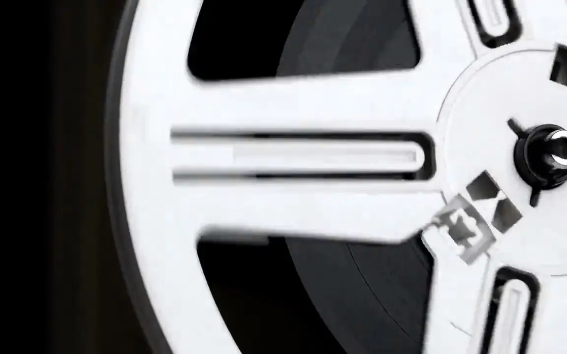 Bobina blanca de una película girando sobre un proyector