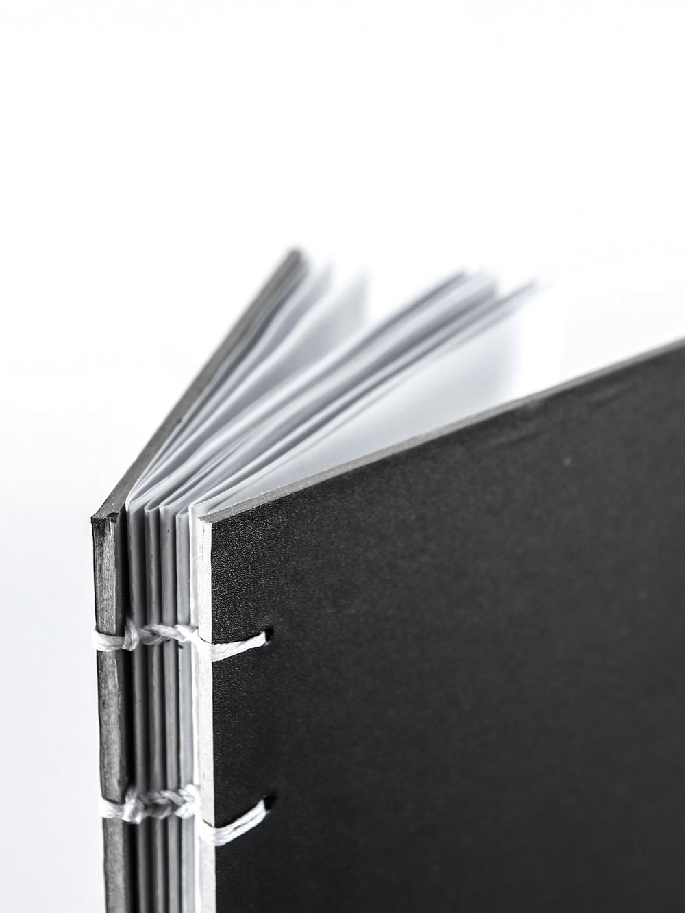 Cuaderno de tapa negra con la costura a la vista