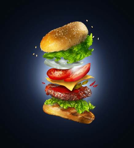 Hamburguesa en el aire sobre fondo azul