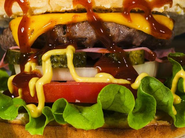 Primer plano de una hamburguesa con salsas