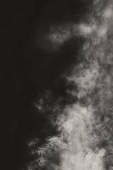 Humo gris que sube sobre un fondo oscuro