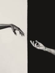 Dos manos que se acercan a través de un fondo dividido en blanco y negro