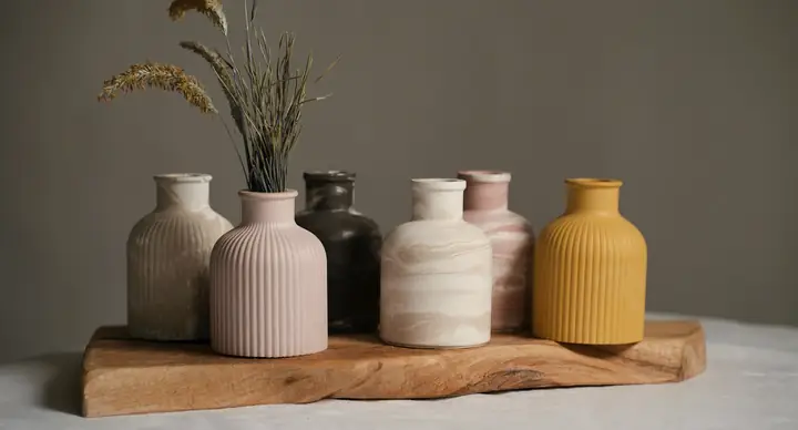 Jarrones de cerámica de colores sobre una tabla de madera