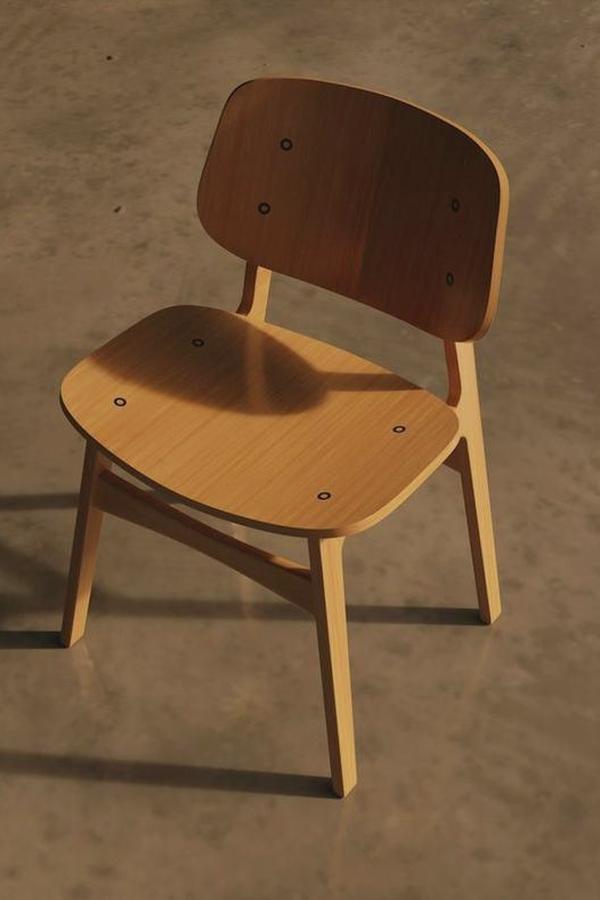 Una silla de madera oscura sobre un suelo de cemento