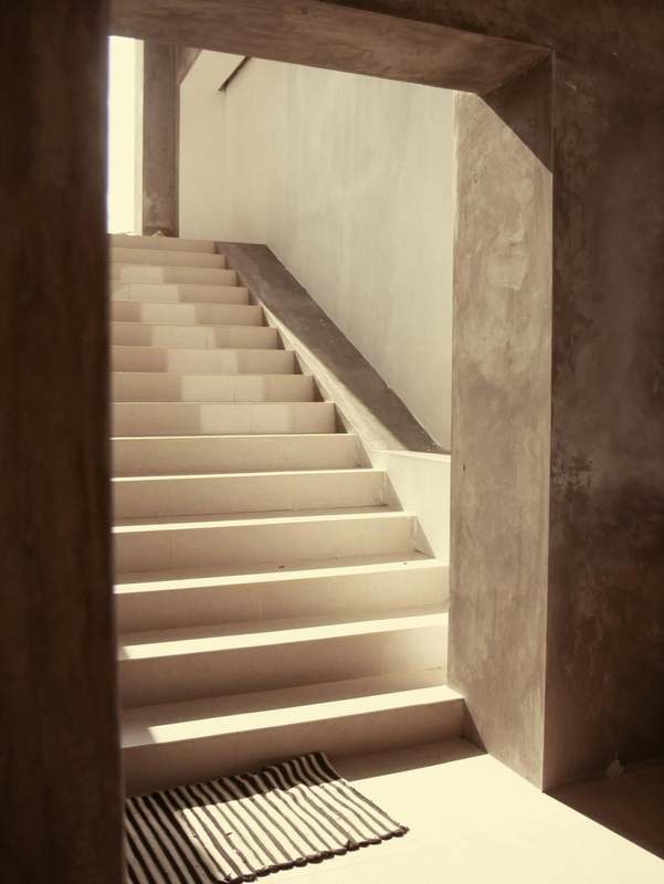 Escalera iluminada entre muros de hormigón